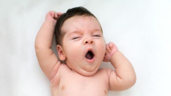 Yawning baby, ready for bedtime.
